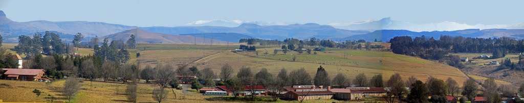Panoramic view over Cedara Agricultural College towards the snow covered Drakensberg Mountains in the far distance.